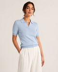 Woman wearing the Dezire Sky light blue knit polo