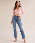 Woman wearing the Dezire Blush soft pink cropped cardigan