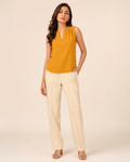 Woman wearing the Dezire Saffron mustard sleeveless top