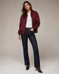 Woman wearing the Dezire Merlot burgundy bomber jacket