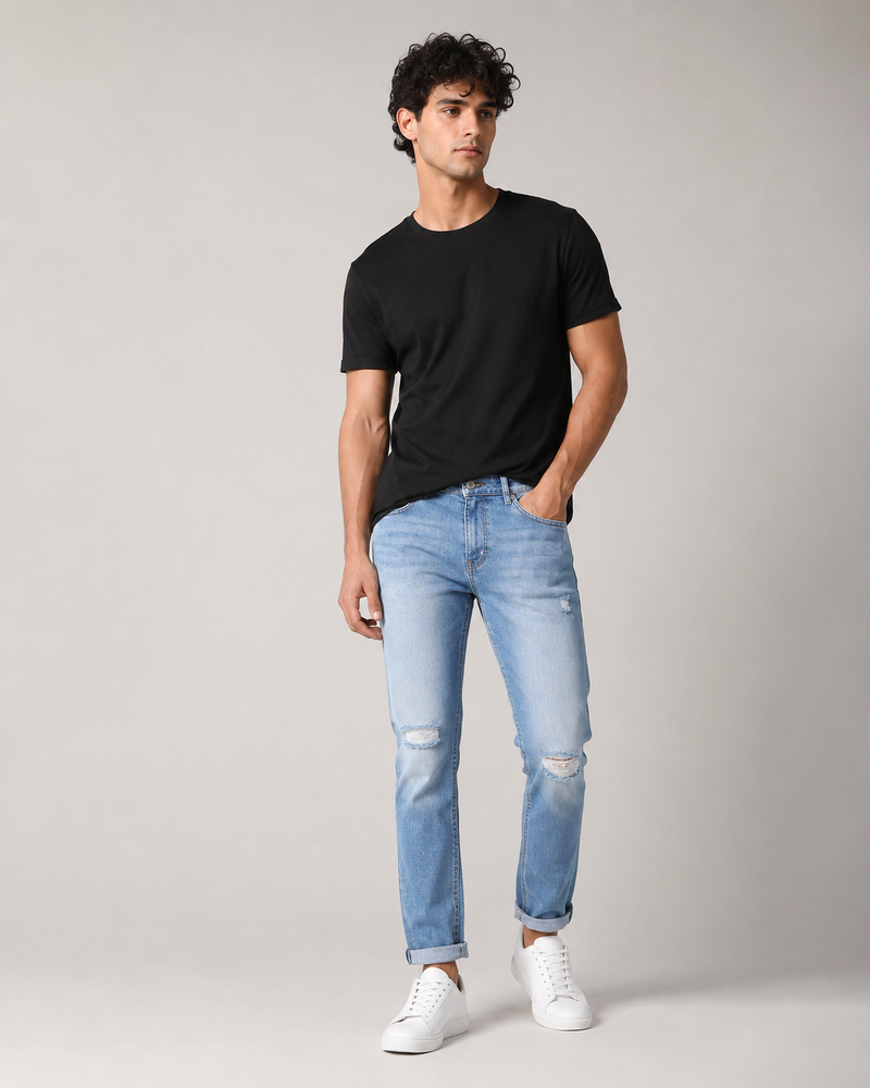 DEZIRE light wash distressed slim jeans for men on a studio model